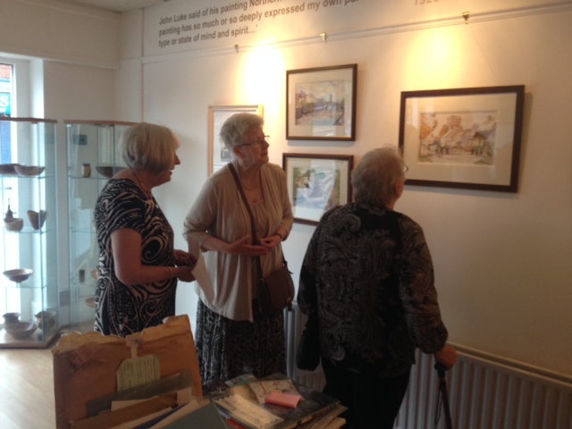 Artists Mary McGrath, Anne Cree and Ellen Smyth admire Wesley Lewis's paintings